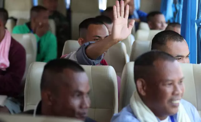 In this photo released by Agence Kampuchea Press (AKP), Cambodian soldiers sit in a van as they arrive after being captured and held by the Thai army, at Prum border gate, in Pailin province, Cambodia, Wednesday, Dec. 31, 2025. (AKP via AP)