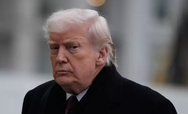 President Donald Trump looks on after stepping off Marine One on the South Lawn of the White House, Wednesday, Dec. 17, 2025, in Washington. (AP Photo/Mark Schiefelbein)