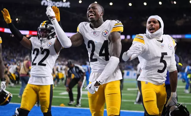 Pittsburgh Steelers' Asante Samuel Jr. (22) Joey Porter Jr. (24) and Jalen Ramsey (5) celebrate after Pittsburgh won an NFL football game against the Detroit Lions, Sunday, Dec. 21, 2025, in Detroit. (AP Photo/Ryan Sun)