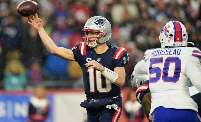 New England Patriots quarterback Drake Maye (10) passes as Buffalo Bills defensive end Greg Rousseau (50) applies pressure during the second half of an NFL football game in Foxborough, Mass., Sunday, Dec. 14, 2025. (AP Photo/Robert F. Bukaty)