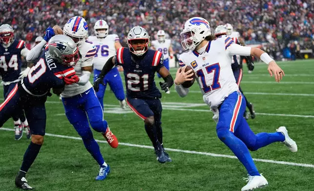 Buffalo Bills quarterback Josh Allen (17) runs against New England Patriots cornerback Christian Gonzalez (0) and safety Jaylinn Hawkins (21) during the second half of an NFL football game in Foxborough, Mass., Sunday, Dec. 14, 2025. (AP Photo/Robert F. Bukaty)