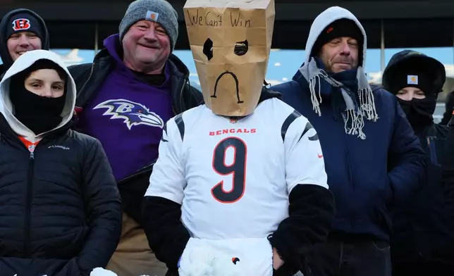 A Cincinnati Bengals fan wears a paper bag over their head after a loss to the Baltimore Ravens in an NFL football game, Sunday, Dec. 14, 2025, in Cincinnati. (AP Photo/Jeff Dean)