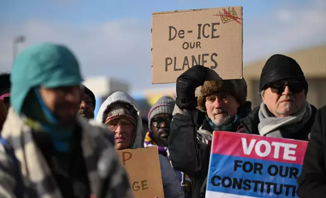 Protesters gather at a rally for immigrant and workers outside Signature Aviation near the Minneapolis–Saint Paul International Airport, Wednesday, Dec 3, 2025, in Minneapolis. (AP Photo/Tom Baker)