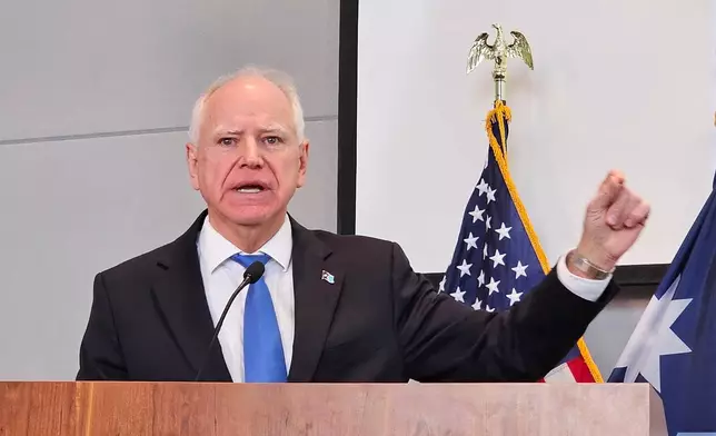 Democratic Gov. Tim Walz, speaking at a news conference on Thursday, Dec. 4, 2025, in St. Paul, denounces President Donald Trump for calling Minnesota's Somali community "garbage" and dismissing the state as a "hellhole." (AP Photo/Steve Karnowski)