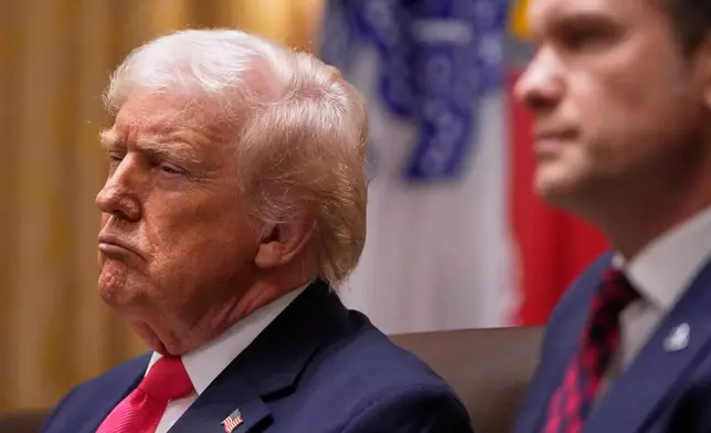 President Donald Trump and Defense Secretary Pete Hegseth listen, during a Cabinet meeting at the White House, Tuesday, Dec. 2, 2025, in Washington. (AP Photo/Julia Demaree Nikhinson)
