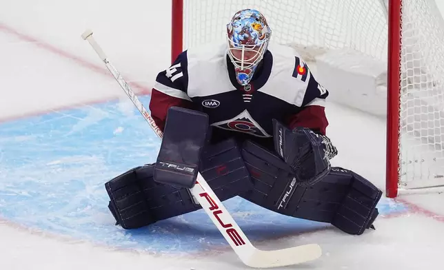 Colorado Avalanche goaltender Scott Wedgewood stops a shot in the first period of an NHL hockey game against the Winnipeg Jets, Friday, Dec. 19, 2025, in Denver. (AP Photo/David Zalubowski)