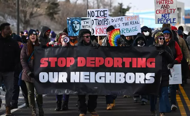 Protesters gather at a rally for immigrants and workers outside Signature Aviation near the Minneapolis–Saint Paul International Airport, Wednesday, Dec 3, 2025, in Minneapolis. (AP Photo/Tom Baker)