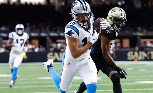 Carolina Panthers wide receiver Jalen Coker (18) catches a touchdown pass against New Orleans Saints cornerback Quincy Riley (29) in the second half of an NFL football game, Sunday, Dec. 14, 2025, in New Orleans. (AP Photo/Butch Dill)