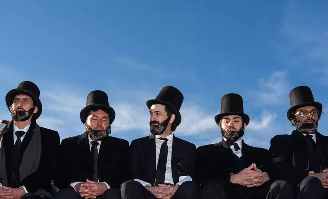 Men dressed as former President Abraham Lincoln attend a mock funeral for the penny, which was discontinued earlier this year, Saturday, Dec. 20, 2025, in front of the Lincoln Memorial in Washington. (AP Photo/Julia Demaree Nikhinson)