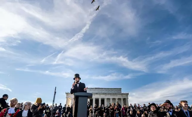 A man dressed as former President Abraham Lincoln speaks at a mock funeral for the penny, which was discontinued earlier this year, Saturday, Dec. 20, 2025, in front of the Lincoln Memorial in Washington. (AP Photo/Julia Demaree Nikhinson)