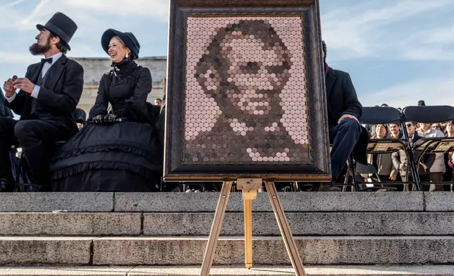 An artwork of former President Abraham Lincoln made out of pennies is displayed at a mock funeral for the penny, which was discontinued earlier this year, Saturday, Dec. 20, 2025, in front of the Lincoln Memorial in Washington. (AP Photo/Julia Demaree Nikhinson)