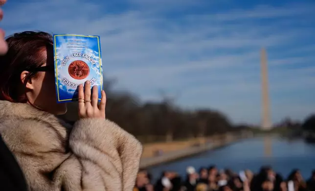 Mourners gather at a mock funeral for the penny, which was discontinued earlier this year, Saturday, Dec. 20, 2025, in front of the Lincoln Memorial in Washington. (AP Photo/Julia Demaree Nikhinson)
