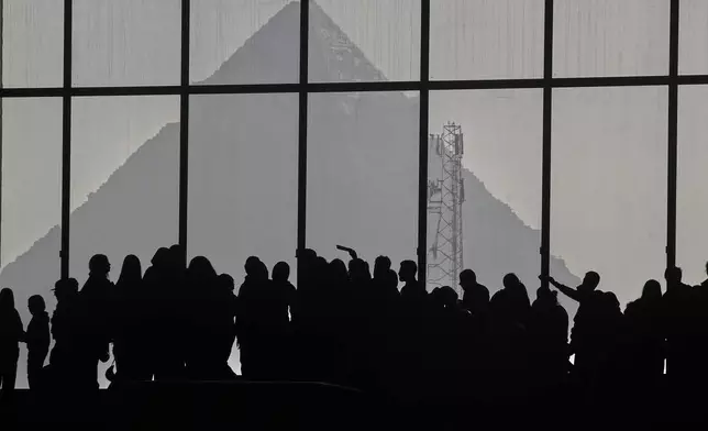 People view the site of the Giza Pyramid, during the second day for visitors after the official opening of the Grand Egyptian Museum in Giza, Egypt, Tuesday, Dec. 23, 2025. (AP Photo/Amr Nabil)