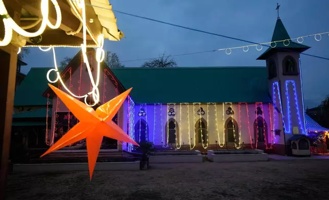 The Holy Family Catholic Church is illuminated ahead of Christmas in Srinagar, Indian controlled Kashmir, Tuesday, Dec. 23, 2025. (AP Photo/Mukhtar Khan)