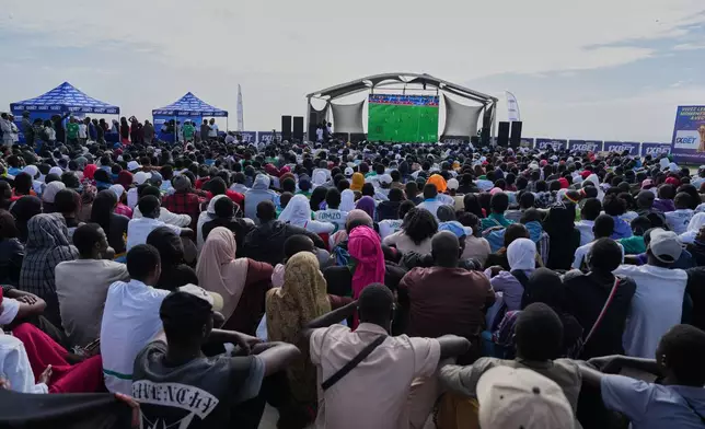 Fans watch a live broadcast of the Africa Cup of Nations group D soccer match between Senegal and Botswana in Dakar, Senegal, Tuesday, Dec. 23, 2025. (AP Photo/Misper Apawu)