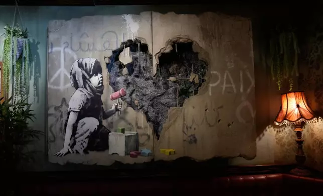 The Walled Off Hotel, designed by anonymous street artist Banksy and now an independent business, reopens its doors after more than two years closure following the Gaza war, in the West Bank city of Bethlehem, Tuesday, Dec. 23, 2025. (AP Photo/Nasser Nasser)