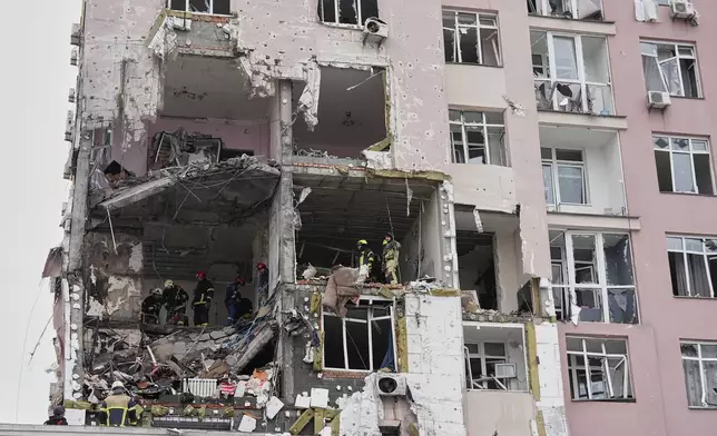 Rescuers work on the scene of a building damaged by a Russian attack in Kyiv, Ukraine, Saturday, Dec. 27, 2025. (AP Photo/Efrem Lukatsky)