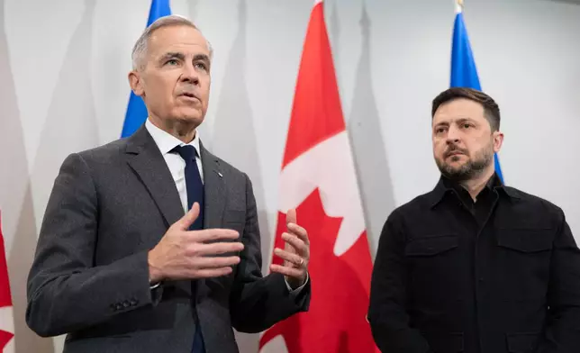 Prime Minister Mark Carney, left, and Ukrainian President Volodymyr Zelenskyy hold a news conference in Halifax, N.S. on Saturday, Dec. 27, 2025.(Riley Smith /The Canadian Press via AP)