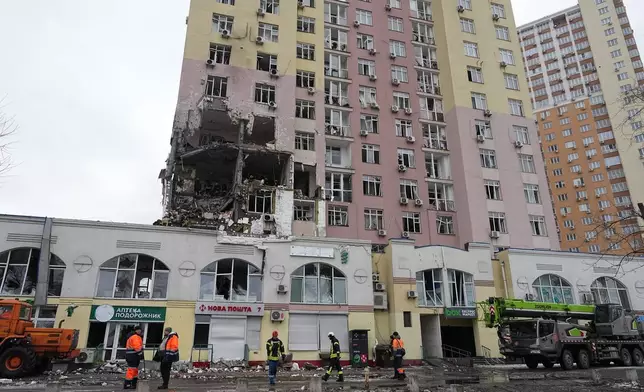 Rescuers work on the scene of a building damaged by a Russian attack in Kyiv, Ukraine, Saturday, Dec. 27, 2025. (AP Photo/Efrem Lukatsky)