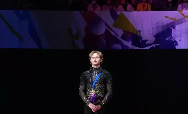Ilia Malinin, of the United States, stands on the podium after winning the gold medal in the men's event at the ISU Grand Prix of Figure Skating Final in Nagoya, central Japan, Saturday, Dec. 6, 2025. (AP Photo/Hiro Komae)