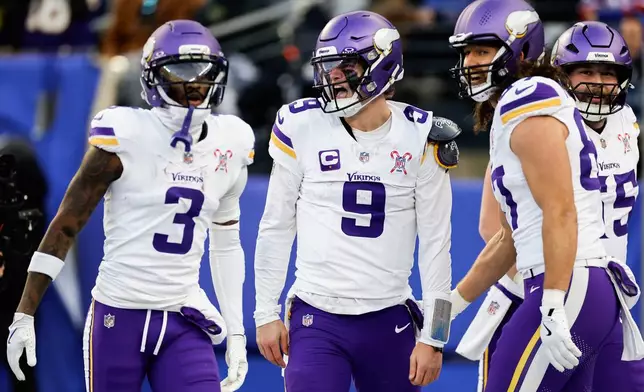 Minnesota Vikings quarterback J.J. McCarthy (9) celebrates with teammates after scoring a touchdown against the New York Giants during the second quarter of an NFL football game, Sunday, Dec. 21, 2025, in East Rutherford, N.J. (AP Photo/Adam Hunger)