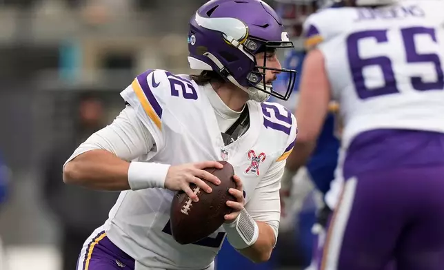 Minnesota Vikings quarterback Max Brosmer (12) looks to pass against the New York Giants during the third quarter of an NFL football game, Sunday, Dec. 21, 2025, in East Rutherford, N.J. (AP Photo/Frank Franklin II)