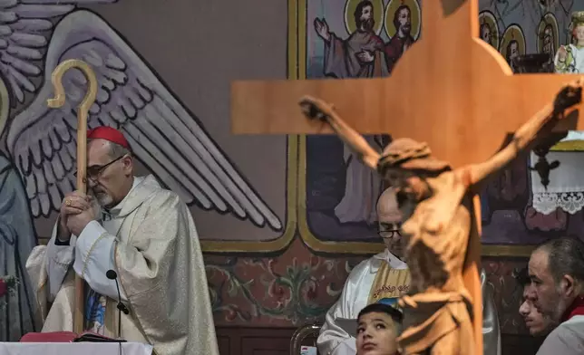 Cardinal Pierbattista Pizzaballa, the Latin Patriarch of Jerusalem, leads a Christmas Eve Mass at the Holy Family Catholic Church in Gaza City, Sunday, Dec. 21, 2025. (AP Photo/Jehad Alshrafi)