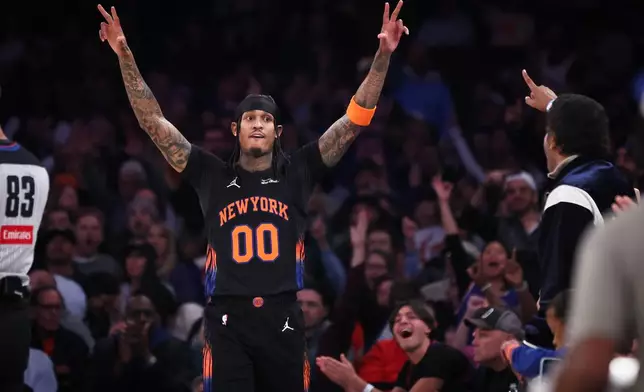 New York Knicks' Jordan Clarkson (00) gestures after scoring a 3-point basket during the first half of an NBA basketball game against the Utah Jazz, Friday, Dec. 5, 2025, in New York. (AP Photo/Heather Khalifa)