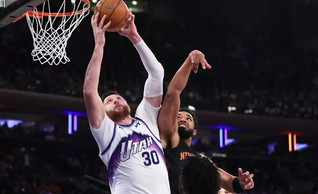 Utah Jazz center Jusuf Nurkic (30) goes up to shoot against New York Knicks center Karl-Anthony Towns, top right, during the first half of an NBA basketball game, Friday, Dec. 5, 2025, in New York. (AP Photo/Heather Khalifa)