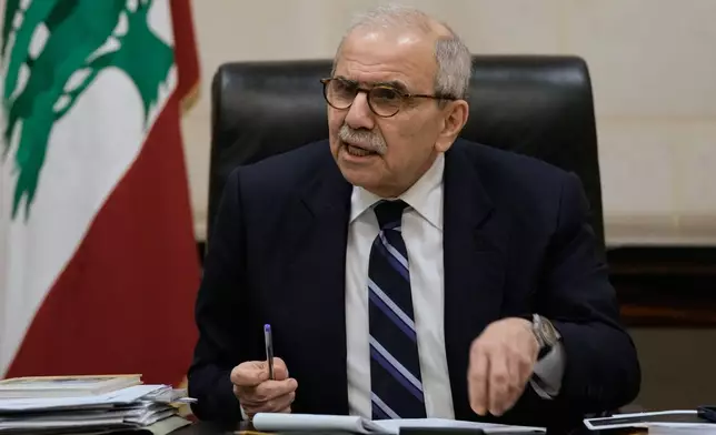 Lebanese Prime Minister Nawaf Salam speaks to journalists working for foreign media and news agencies at the government palace in Beirut, Wednesday, Dec. 3, 2025. (AP Photo/Bilal Hussein)