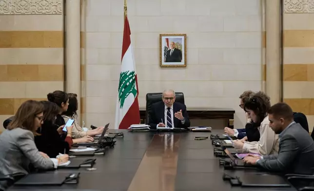 Lebanese Prime Minister Nawaf Salam meets with journalists working for foreign media and news agencies at the government palace in Beirut, Wednesday, Dec. 3, 2025. (AP Photo/Bilal Hussein)