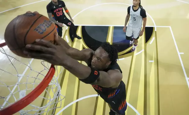 New York Knicks forward Og Anunoby (8) dunks the ball against the San Antonio Spurs during an NBA Cup championship basketball game, Tuesday, Dec. 16, 2025, in Las Vegas. (Kirby Lee/Pool Photo via AP)