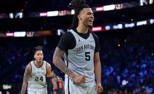 San Antonio Spurs guard Stephon Castle (5) reacts after a dunk against the New York Knicks during the first half of the NBA Cup championship basketball game Tuesday, Dec. 16, 2025, in Las Vegas. (AP Photo/Ian Maule)