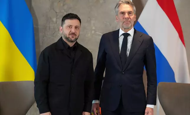 Dutch Prime Minister Dick Schoof, right, poses with Ukraine's President Volodymyr Zelenskyy in The Hague, Netherlands, Tuesday, Dec. 16, 2025. (AP Photo/Peter Dejong)