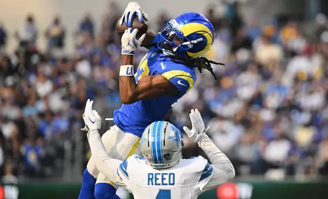 Los Angeles Rams wide receiver Davante Adams (17) makes a catch over Detroit Lions cornerback D.J. Reed (4) during the first half of an NFL football game Sunday, Dec. 14, 2025, in Inglewood, Calif. (AP Photo/Katie Chin)