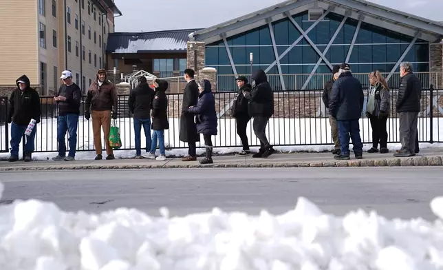 People wait in line to hear President Donald Trump speak at the Mount Airy Casino Resort in Mt. Pocono, Pa., Tuesday, Dec. 9, 2025. (AP Photo/Matt Rourke)