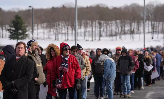 People wait in line to hear President Donald Trump speak at the Mount Airy Casino Resort in Mt. Pocono, Pa., Tuesday, Dec. 9, 2025. (AP Photo/Matt Rourke)