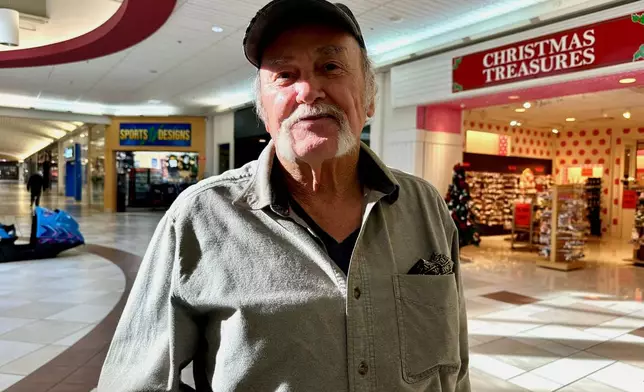 Lou Heddy, 72, poses for a photo while shopping at the Stroud Mall, Dec. 9, 2025, in Stroudsburg, Pa. (AP Photo/Marc Levy)
