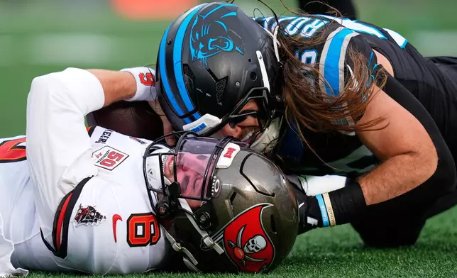 Tampa Bay Buccaneers quarterback Baker Mayfield is sacked by Carolina Panthers linebacker Christian Rozeboom during the first half of an NFL football game, Sunday, Dec. 21, 2025, in Charlotte, N.C. (AP Photo/Erik Verduzco)