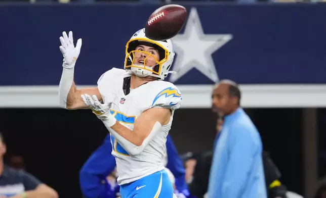 Los Angeles Chargers wide receiver Ladd McConkey (15) makes a touchdown catch during the first half of an NFL football game against the Dallas Cowboys, Sunday, Dec. 21, 2025, in Arlington, Texas. (AP Photo/Julio Cortez)