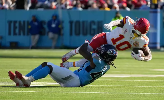 Kansas City Chiefs running back Isiah Pacheco (10) is tackled by Tennessee Titans cornerback Kemon Hall (40) during the first half of an NFL football game, Sunday, Dec. 21, 2025, in Nashville, Tenn. (AP Photo/George Walker IV)