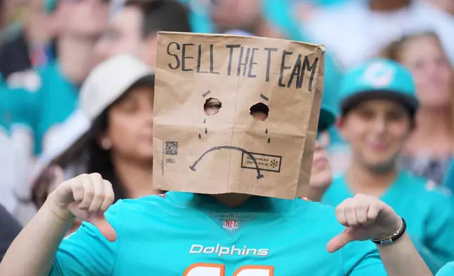 A Miami Dolphins fans shows his displeasure during the first half of an NFL football game against the Cincinnati Bengals, Sunday, Dec. 21, 2025, in Miami Gardens, Fla. (AP Photo/Rebecca Blackwell)