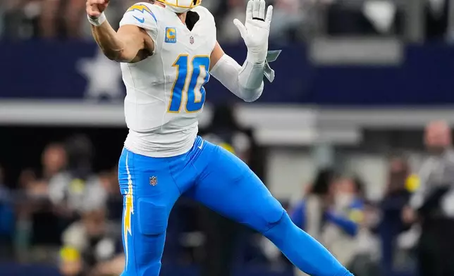 Los Angeles Chargers quarterback Justin Herbert (10) throws a pass during the first half of an NFL football game against the Dallas Cowboys, Sunday, Dec. 21, 2025, in Arlington, Texas. (AP Photo/Tony Gutierrez)