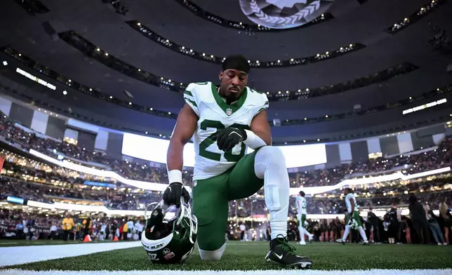 New York Jets running back Breece Hall pauses before an NFL football game against the New Orleans Saints, Sunday, Dec. 21, 2025, in New Orleans. (AP Photo/Ella Hall)