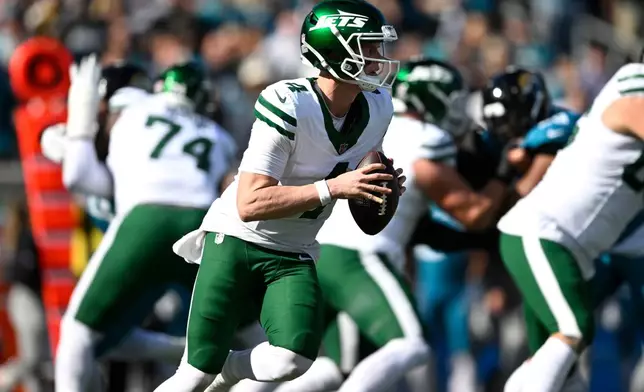 New York Jets quarterback Brady Cook looks to pass against the Jacksonville Jaguars during the first half of an NFL football game, Sunday, Dec. 14, 2025, in Jacksonville, Fla. (AP Photo/Phelan M. Ebenhack)