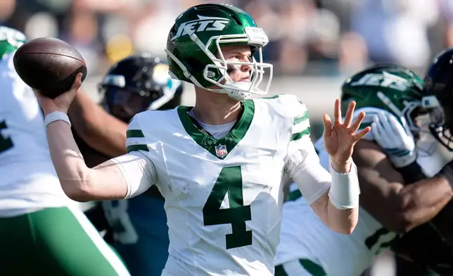 New York Jets quarterback Brady Cook (4) looks to throw a pass against the Jacksonville Jaguars during the first half of an NFL football game, Sunday, Dec. 14, 2025, in Jacksonville, Fla. (AP Photo/John Raoux)