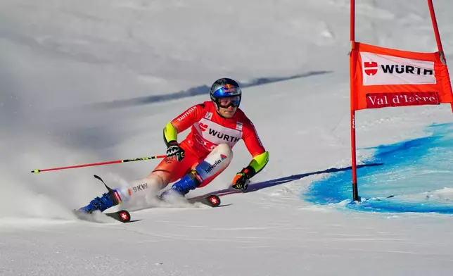 Switzerland's Marco Odermatt speeds down the course during an alpine ski, men's World Cup giant slalom event, in Val d'Isere, France, Saturday Dec. 13, 2025. (AP Photo/Pier Marco Tacca)