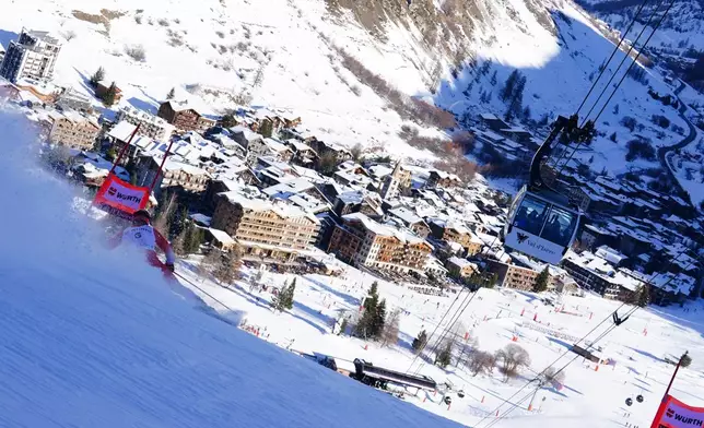 Switzerland's Loic Meillard speeds down the course during an alpine ski, men's World Cup giant slalom event, in Val d'Isere, France, Saturday Dec. 13, 2025. (AP Photo/Pier Marco Tacca)