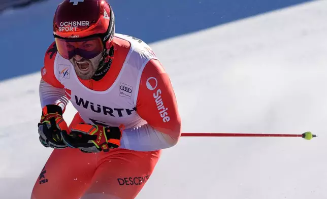 Switzerland's Loic Meillard reacts after completing an alpine ski, men's World Cup giant slalom event, in Val d'Isere, France, Saturday Dec. 13, 2025. (AP Photo/Giovanni Auletta)