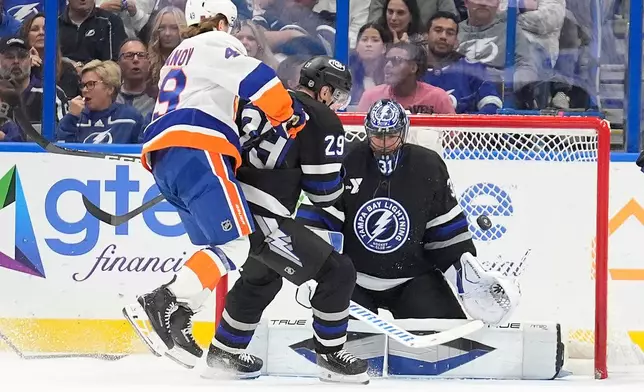 Tampa Bay Lightning goaltender Jonas Johansson (31) makes a save on a shot by New York Islanders right wing Max Shabanov (49) during the second period of an NHL hockey game Saturday, Dec. 6, 2025, in Tampa, Fla. (AP Photo/Chris O'Meara)